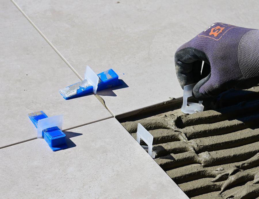 Floor tiles being positioned during installation